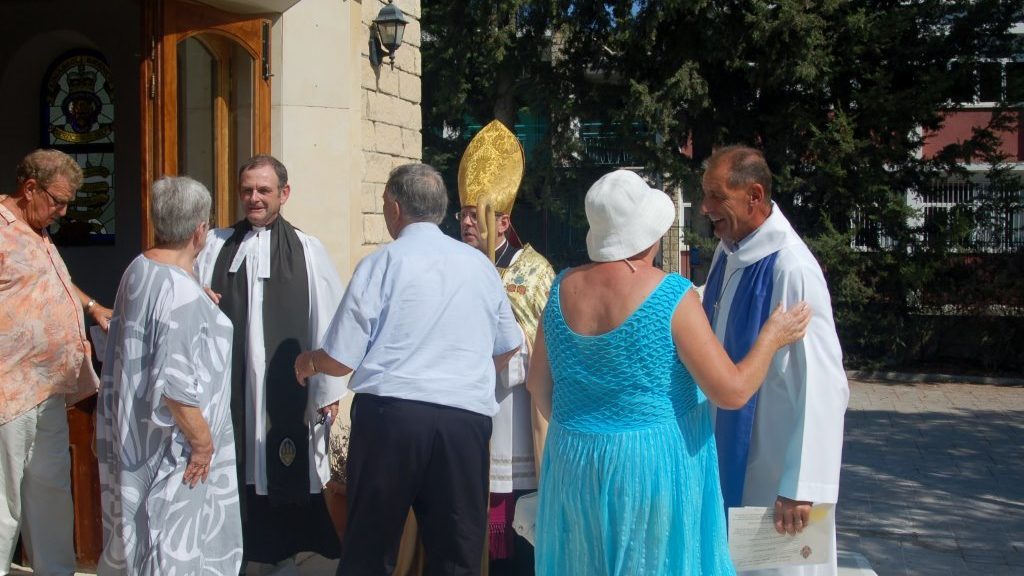 Greeting members of the congregation after the service